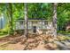 Charming home featuring a well-manicured front yard with mature trees providing shade at 5372 Martins Crossing Rd, Stone Mountain, GA 30088