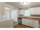 Bright kitchen with white cabinets, stainless steel appliances, and wood-look flooring at 5372 Martins Crossing Rd, Stone Mountain, GA 30088