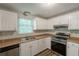 Modern kitchen featuring stainless steel appliances, wood look flooring, and ample cabinet space at 5372 Martins Crossing Rd, Stone Mountain, GA 30088