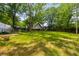 Expansive backyard featuring lush grass and mature trees, perfect for outdoor activities and relaxation at 638 Medford Se Pl, Smyrna, GA 30080