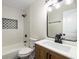 Modern bathroom features tiled shower/tub with black hardware, updated vanity, and great lighting at 638 Medford Se Pl, Smyrna, GA 30080