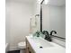 Modern bathroom features a sleek vanity, black fixtures, and elegant mirror and is well lit with great natural light at 638 Medford Se Pl, Smyrna, GA 30080
