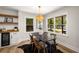 Bright dining area with modern chandelier, floating shelves and beverage cooler at 638 Medford Se Pl, Smyrna, GA 30080