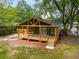 Charming home featuring a covered porch, wood accents, and a cozy outdoor space for entertaining at 638 Medford Se Pl, Smyrna, GA 30080