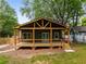 Charming home featuring a covered porch, wood accents, and a cozy outdoor space at 638 Medford Se Pl, Smyrna, GA 30080