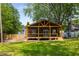 Charming home featuring a covered porch, wood accents, and a cozy outdoor space for entertaining at 638 Medford Se Pl, Smyrna, GA 30080