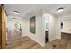 Hallway leading to rooms, bathroom, and living room, with artwork and a sliding barn door at 638 Medford Se Pl, Smyrna, GA 30080