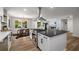 Open concept kitchen features stainless steel appliances, a large island, and views of dining and living areas at 638 Medford Se Pl, Smyrna, GA 30080