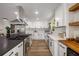 Bright kitchen featuring white cabinets, stainless steel appliances, a large island, and modern finishes at 638 Medford Se Pl, Smyrna, GA 30080