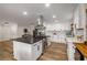 Spacious kitchen features stainless steel appliances, a large island, white cabinets, and modern finishes at 638 Medford Se Pl, Smyrna, GA 30080