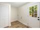 Bright laundry room with door to the outside and a built-in closet at 638 Medford Se Pl, Smyrna, GA 30080