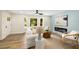 Inviting living room featuring a shiplap wall, modern fireplace, and comfortable seating with natural light at 638 Medford Se Pl, Smyrna, GA 30080