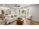 Bright living room with a white sofa, wood floors, and a large front window letting in natural light at 638 Medford Se Pl, Smyrna, GA 30080