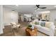 Open-concept living room featuring a white sofa, wood floors, and seamless flow to the modern kitchen at 638 Medford Se Pl, Smyrna, GA 30080