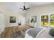 This main bedroom has a ceiling fan, a sitting area, and a view of the backyard at 638 Medford Se Pl, Smyrna, GA 30080