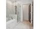 Luxurious bathroom with marble tiles, frameless shower, and soaking tub at 808 Angora Aly, Scottdale, GA 30079