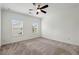 Bright, carpeted bedroom with ceiling fan and two windows with views at 808 Angora Aly, Scottdale, GA 30079
