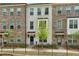 Charming townhome featuring a brick facade, black iron fence, and well-maintained landscaping at 808 Angora Aly, Scottdale, GA 30079