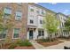 Stylish townhome showcasing brick and painted brickwork with a inviting, landscaped entrance at 808 Angora Aly, Scottdale, GA 30079
