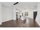 Bright kitchen featuring an island, stainless steel appliances, dark wood floors, and modern lighting at 808 Angora Aly, Scottdale, GA 30079