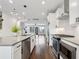 Modern kitchen with stainless steel appliances, white cabinets, and a view to the living space at 808 Angora Aly, Scottdale, GA 30079
