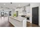 Open-concept kitchen with stainless steel appliances, quartz countertops, and eat in kitchen island at 808 Angora Aly, Scottdale, GA 30079