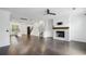 Open concept living room with wood floors, stone fireplace, and bright windows at 808 Angora Aly, Scottdale, GA 30079