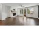 Bright living room with fireplace, dark wood floors, and exterior door at 808 Angora Aly, Scottdale, GA 30079