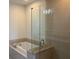 Bathroom featuring a soaking tub, a glass enclosed shower, and modern fixtures at 1080 Peachtree Ne St # 2915, Atlanta, GA 30309