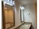 Bright bathroom with a large mirror, granite countertop, and modern lighting at 1080 Peachtree Ne St # 2915, Atlanta, GA 30309