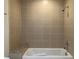 A tiled bathtub with built in granite shelf is perfect for relaxing after a long day at 1080 Peachtree Ne St # 2915, Atlanta, GA 30309