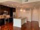 Modern kitchen with stainless steel appliances, an island, and dark wood cabinets at 1080 Peachtree Ne St # 2915, Atlanta, GA 30309