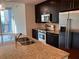 Modern kitchen featuring granite countertops, stainless steel appliances, and dark wood cabinets at 1080 Peachtree Ne St # 2915, Atlanta, GA 30309