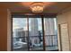 Living room area with large windows that show a skyline and hanging light fixture at 1080 Peachtree Ne St # 2915, Atlanta, GA 30309
