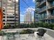 Cozy patio space with modern furniture and verdant landscaping, perfect for relaxing and entertaining at 1080 Peachtree Ne St # 2915, Atlanta, GA 30309