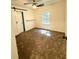 Bright bedroom featuring neutral carpet, ceiling fan, and a large window at 1700 Devon Sw Dr, Atlanta, GA 30311