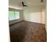 Spacious bedroom featuring ceiling fan, plush carpet, and large window at 1700 Devon Sw Dr, Atlanta, GA 30311