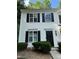 Charming townhome with white siding, black shutters, and well-maintained landscaping at 1700 Devon Sw Dr, Atlanta, GA 30311