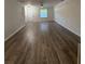 Spacious living room featuring stairs and wood-look flooring at 1700 Devon Sw Dr, Atlanta, GA 30311