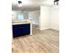 Open-concept living room with hardwood flooring, granite counters and natural light at 1700 Devon Sw Dr, Atlanta, GA 30311