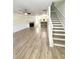 Bright open-concept living room with fireplace, ceiling fan and stairs leading to the second level at 1700 Devon Sw Dr, Atlanta, GA 30311