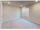 Neutral bedroom with a carpeted floor and standard window with blinds; the recessed lighting provides ample illumination at 3 Roving Hills Cir, Cartersville, GA 30121