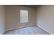 Neutral bedroom with a carpeted floor and standard window with blinds. The space is well-suited for a variety of uses at 3 Roving Hills Cir, Cartersville, GA 30121