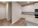 Modern kitchen with white cabinets, granite countertops, and stainless steel appliances at 3 Roving Hills Cir, Cartersville, GA 30121