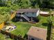 Aerial view of a backyard with a fire pit, storage shed, and multi-level decks and patios at 445 Brownell Ave, Scottdale, GA 30079