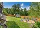 Spacious backyard featuring a fire pit, seating area, storage shed and lush landscaping at 445 Brownell Ave, Scottdale, GA 30079