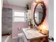 Stylish bathroom with an ornate mirror, granite countertop, and soft, elegant design at 445 Brownell Ave, Scottdale, GA 30079