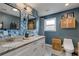 Modern bathroom featuring dual vanity, statement mirrors and beautiful blue wallpaper at 445 Brownell Ave, Scottdale, GA 30079