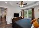 Relaxing bedroom featuring tray ceilings, large windows, and elegant furnishings at 445 Brownell Ave, Scottdale, GA 30079