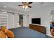 Bedroom with tray ceilings, barn doors and modern closet storage space with mounted television at 445 Brownell Ave, Scottdale, GA 30079